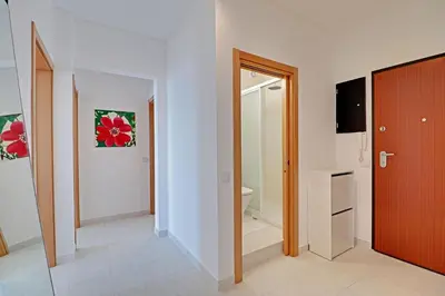 a hallway with a door and a room with a bathroom at Quarteira Beach & Ocean View by Homing in Quarteira