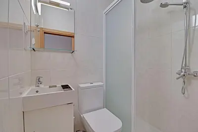 a bathroom with a toilet and a sink and a shower at Quarteira Beach & Ocean View by Homing in Quarteira