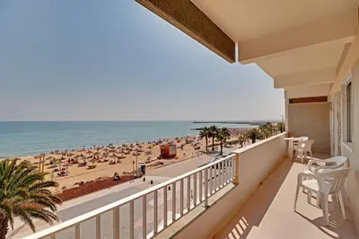 a balcony with a view of the beach at Quarteira Beach & Ocean View by Homing in Quarteira