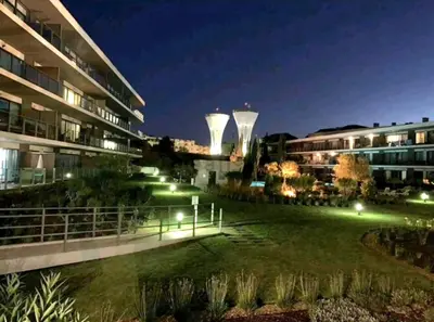 a view of a building with two towers at night at Residence Golf Club-Vilamoura-Algarve in Vilamoura