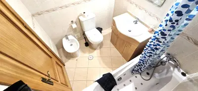 a bathroom with a sink and a toilet and a shower at Holidays - Albufeira in Albufeira