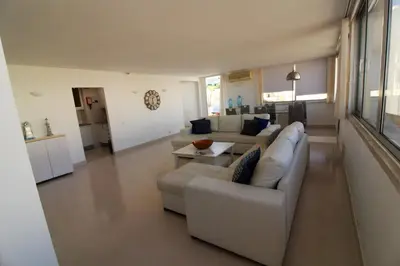 a living room with a couch and a table at Happy Place - Albufeira in Albufeira