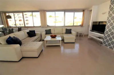 a living room with a couch and a table at Happy Place - Albufeira in Albufeira