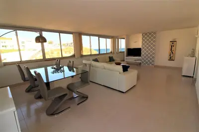 a living room with a white couch and a table at Happy Place - Albufeira in Albufeira