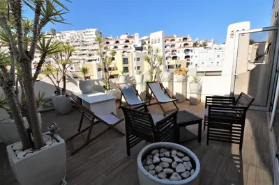 a balcony with chairs and a table on a building at Happy Place - Albufeira in Albufeira