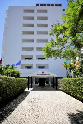 a building with a sign that reads embassy for mum at Sea View Apartment - 3 Swimming Pool & Fitness in Albufeira