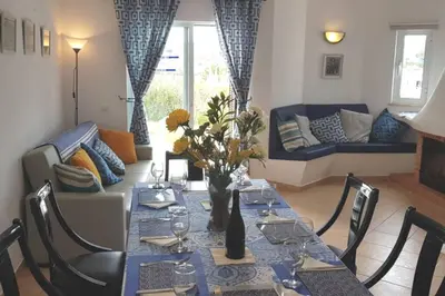 a living room with a table with a blue table cloth at Casa Anna Del Rey. sth.faceing with free wifi. in Albufeira