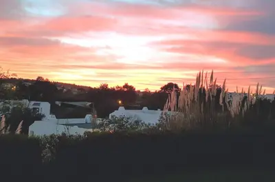 a sunset over a field with buildings and grass at Casa Anna Del Rey. sth.faceing with free wifi. in Albufeira