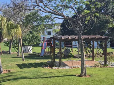 a playground in a park with a tree at Casa Anna Del Rey. sth.faceing with free wifi. in Albufeira