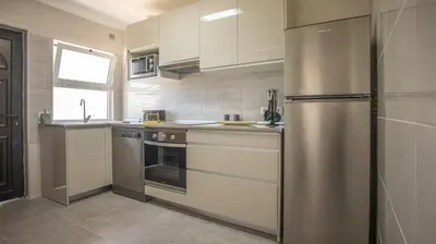 a kitchen with a stainless steel refrigerator at Villa Pedro - Swimming Pool - BY BEDZY in Albufeira