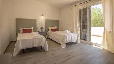 a bedroom with two beds and a large window at Villa Pedro - Swimming Pool - BY BEDZY in Albufeira