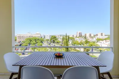 a table and chairs on a balcony with a view at Casa Europa in Vilamoura