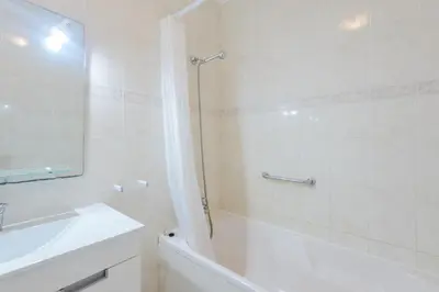a bathroom with a tub and a sink and a shower at Casa Europa in Vilamoura