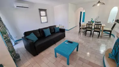 a living room with a couch and a table at Casa da Praia by Sunny Deluxe in Albufeira