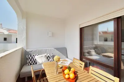a balcony with a table with fruit on it at Apt 1 Quarto, Piscina, AC, Varanda, Prestige For Home in Vilamoura
