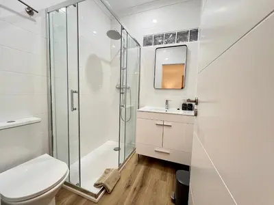 a bathroom with a shower and a toilet and a sink at Vila Sophia, Vilamoura- By Urbinvest Algarve in Vilamoura