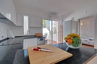 a kitchen with a bowl of fruit on a counter at Casa Roos Loïs in Albufeira