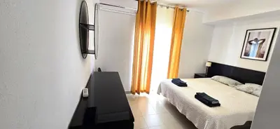 a bedroom with a bed and a window at Historic Centre A - Albufeira in Albufeira