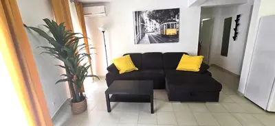 a living room with a yellow table and chairs at Historic Centre A - Albufeira in Albufeira