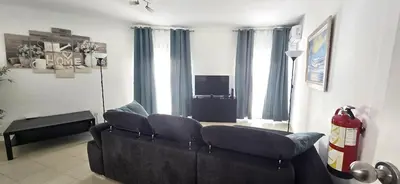 a kitchen and living room with a table and a couch at Historic Centre B - Albufeira in Albufeira