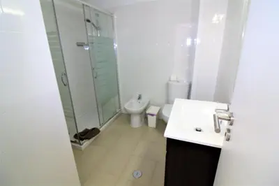 a bathroom with a shower and a sink and a toilet at Historic Centre C - Albufeira in Albufeira