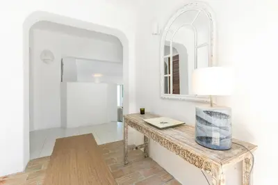 a room with a table and a mirror at Villa Saragoça in Loulé
