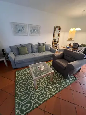 a living room with a couch and a coffee table at Apartamento Surpresa in Albufeira