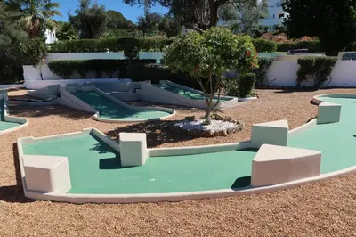 a playground with three trampolines in a yard at Apartamento Surpresa in Albufeira
