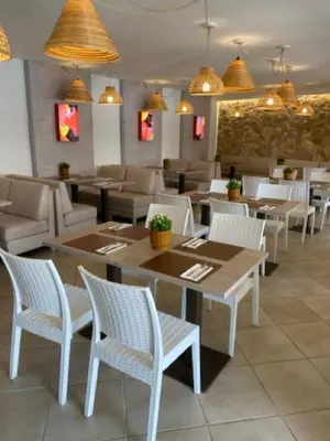 a dining room with tables and chairs in a restaurant at Apartamento Surpresa in Albufeira