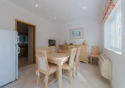 a dining room with a table and chairs at Villa 29 by Garvetur in Vale do Lobo