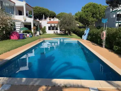 a swimming pool in the backyard of a house at Falésia 25 in Albufeira
