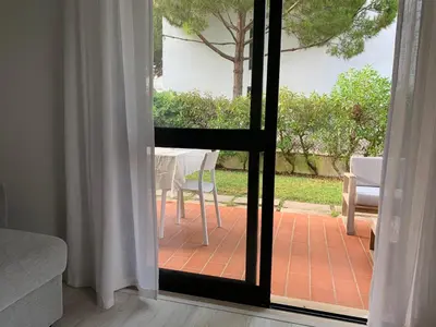 a door to a patio with a table and a chair at Falésia 25 in Albufeira