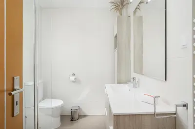 a white bathroom with a toilet and a sink at Hopstays Vilamoura Aldeia do Golfe - House C3 in Vilamoura