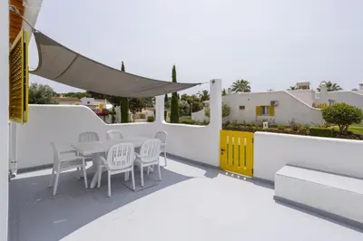 a patio with a table and chairs on a balcony at Hopstays Vilamoura Aldeia do Golfe - House C3 in Vilamoura