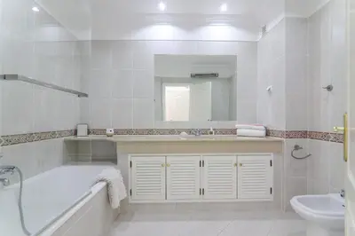 a bathroom with a toilet and a sink at Villa Karon in Almancil