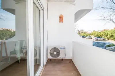 a balcony with a fan and a view of a street at Bambu Villa in Albufeira