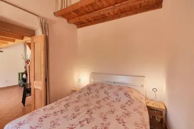 a bedroom with a bed with a floral bedspread at Villa 3 Quartos, Piscina, AC, Vista Mar, Prestige For Home in Loulé