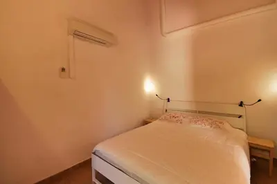 a small bedroom with a bed with white sheets at Villa 3 Quartos, Piscina, AC, Vista Mar, Prestige For Home in Loulé