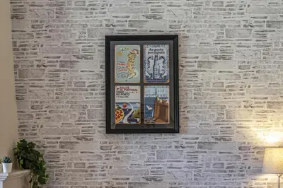 a picture on a brick wall with posters on it at Real Alegria - Terrace with pool - Vilamoura in Vilamoura