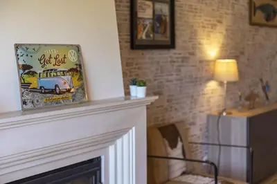 a living room with a fireplace and a picture of a truck at Real Alegria - Terrace with pool - Vilamoura in Vilamoura