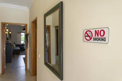 a no smoking sign on a wall next to a mirror at Real Alegria - Terrace with pool - Vilamoura in Vilamoura