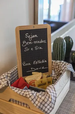 a crate filled with books and a chalkboard at Real Alegria - Terrace with pool - Vilamoura in Vilamoura