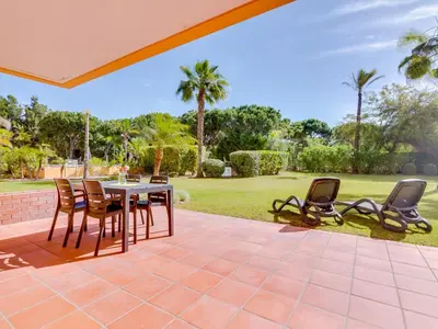 an outdoor patio with a table and chairs at AL - Apartamento Vila Sol F5 P in Vilamoura