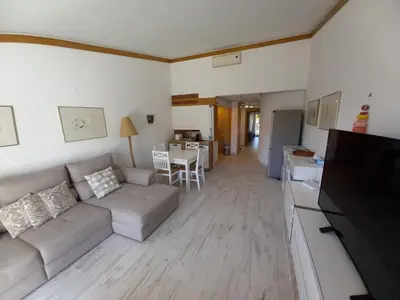 a living room with a couch and a table at Quinta do Lago - Beach,Ténis, Bikes in Quinta do Lago
