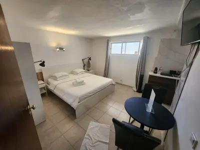 a bedroom with a bed and a table and a desk at AAA APARTAMENTS T0 Piscina Marina in Albufeira