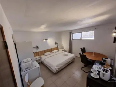 a hotel room with a bed and a table at AAA APARTAMENTS T0 Piscina Marina in Albufeira