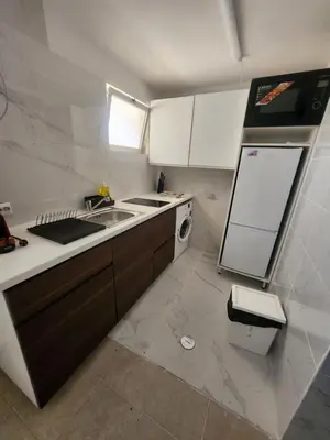 a small kitchen with a sink and a refrigerator at AAA APARTAMENTS T0 Piscina Marina in Albufeira