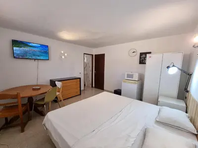 a bedroom with a bed and a desk and a table at AAA APARTAMENTS T0 Piscina Marina in Albufeira