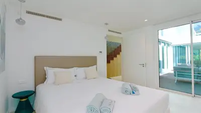 a bedroom with a white bed with two towels on it at Villa Terese-CleverDetails, Central Vilamoura, Sleeps 6, luxury, walking distance in Vilamoura