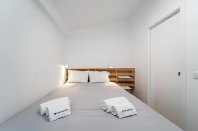 a bedroom with a bed with two towels on it at Casa da Bateria by HelloVacations in Albufeira